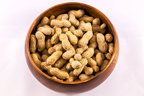 istock Wooden Tray Shelled Peanuts 610437582