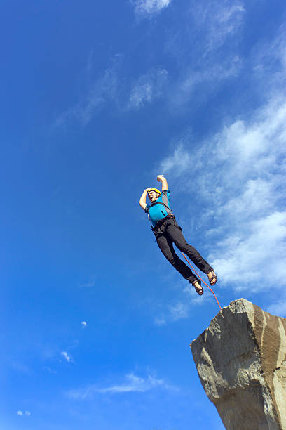 istock Jump rope from a high rock in the mountains. 610437602