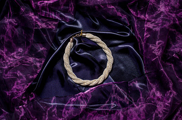 istock gold necklace on a silk background 610438000