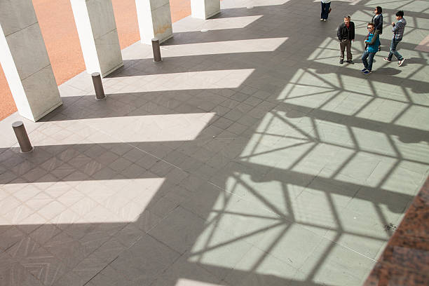 Sun shining through the circular openings of a modern architectural structure in eindhoven, netherlands