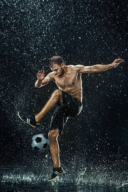istock Water drops around football player 610438770