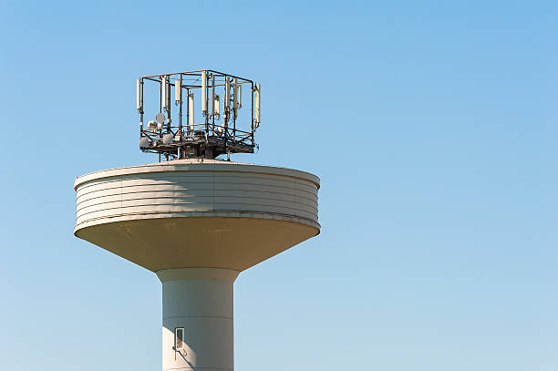 istock Water tank tower surmounted with a telephone repeater antennas 610439258