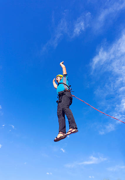 istock Jump rope from a high rock in the mountains. 610439954