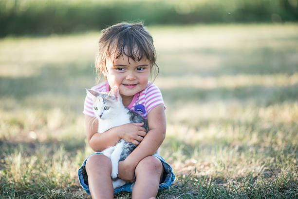 istock Cute Little Girl Holding Her Kitten 610440310