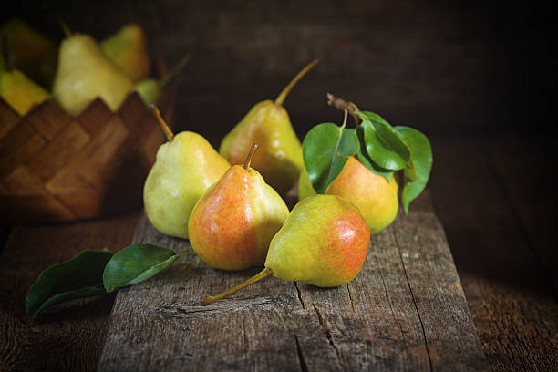 istock Ripe yellow pears lying on a wooden serface 610440486
