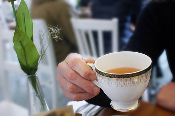 istock Adult man drinking hot tea in cafe 610440746