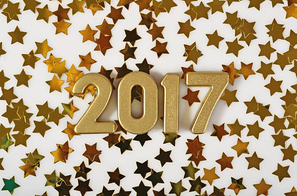 istock 2017 year golden figures and golden stars on a white 610441164