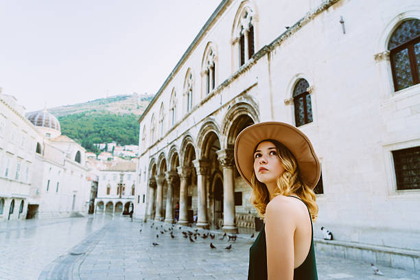 Woman in Dubrovnik od town Young woman walking on the streets of Dubrovnik old town, Croatia dubrovnik stock pictures, royalty-free photos & images