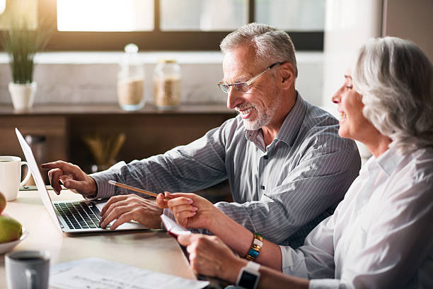 istock Old man typing while woman pointing at the screen 610443622