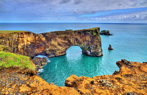 Natural arch of Dyrholaey Peninsula - Iceland Natural arch of Dyrholaey Peninsula in South Iceland peninsula stock pictures, royalty-free photos & images