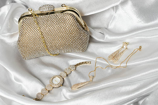 set of women's accessories on a white silk background
