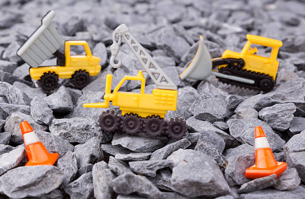 istock crane,dumper truck and bulldozer on pebbles 610445642