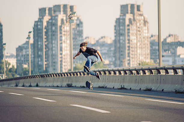 istock Skater doing tricks and jumping on the street highway bridge 610446060