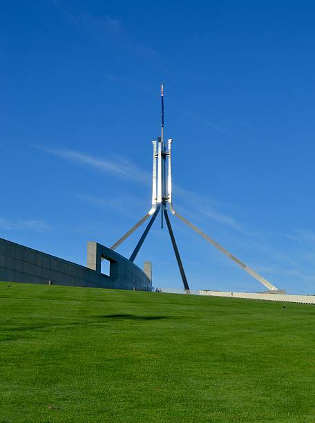 Lawn leading to spire on Parliament House Canberra Australia stock photo