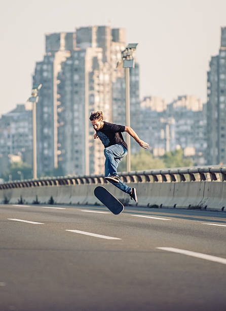istock Skater doing tricks and jumping on the street highway bridge 610447062