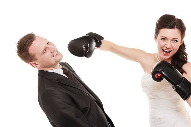 istock Wedding couple. Bride boxing groom. Conflict. 610447216