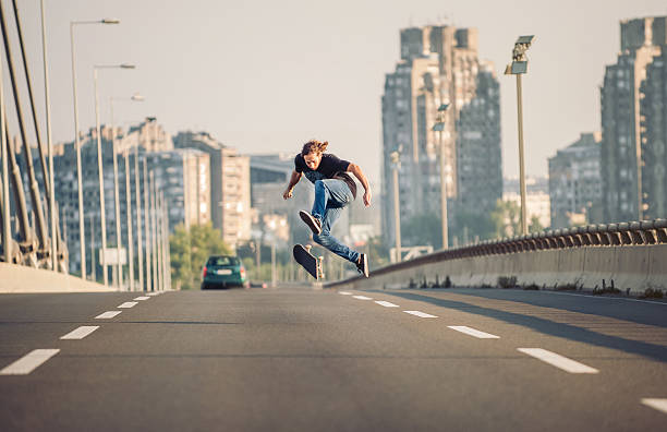 istock Skater doing tricks and jumping on the street highway bridge 610447284