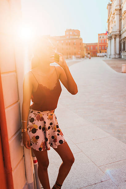 young woman talking on the smartphone,strong sun light