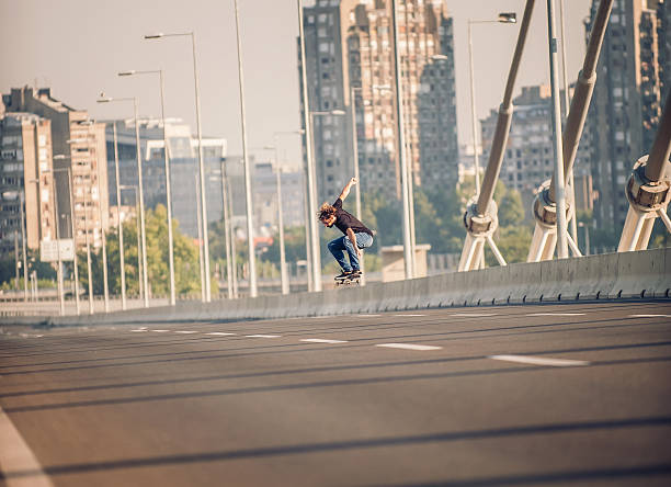 istock Skater doing tricks and jumping on the street highway bridge 610447778