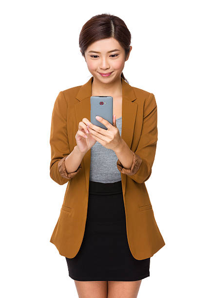 istock Businesswoman using smartphone 610450360