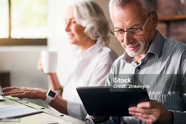 Elderly Couple Together At The Kitchen Stock Photo - Download Image Now - Senior Adult, Retirement, Laptop