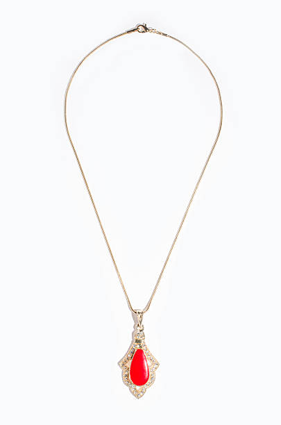 istock Indian gold pendant with red gem on a white background 610451876