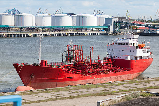 istock Large red ship docked in the port 610452050