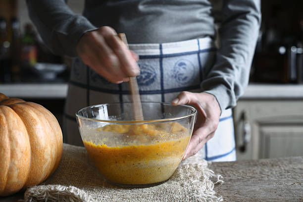 istock Mixing dough for pumpkin dump cake in glass bowl horizontal 610453398