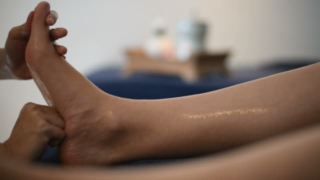Foot massage in spa salon.
