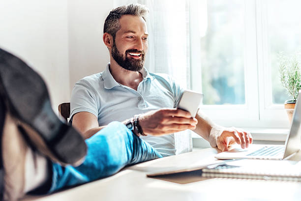istock lucky bearded man makes business in the web at home 610539976