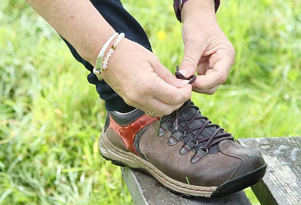 istock Tying shoelace of walking boot 610539980
