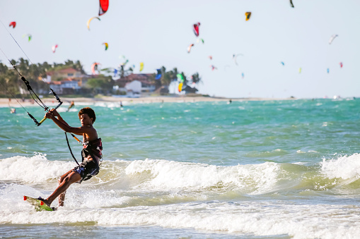 Kiteboarding. kite surfer rides the waves. Sports activity. Kitesurfing action.