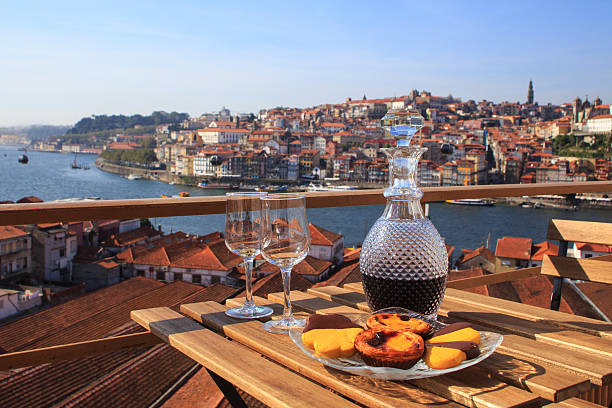 Port wine with a view Table with view a wonderful view over the river in Porto, Portugal. camellia sinensis photos stock pictures, royalty-free photos & images