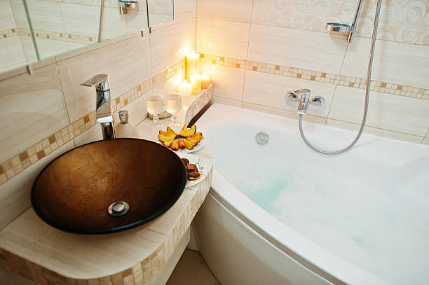 istock Modern washbasin in bathroom with burning candles 610545116