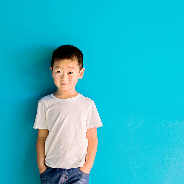 istock Chinese little boy against wall 610545394