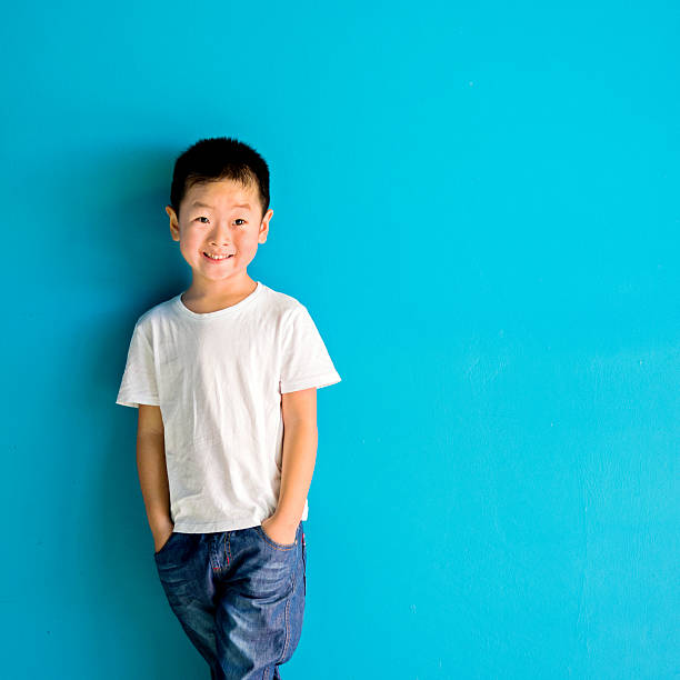 istock Chinese little boy against wall 610545604