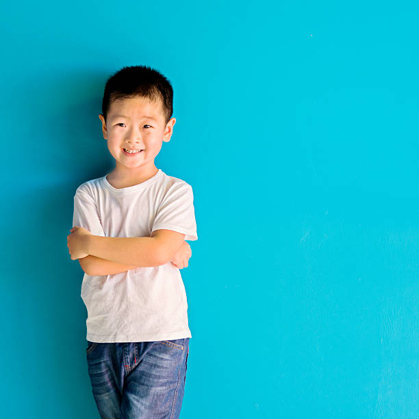 istock Chinese little boy against wall 610546172