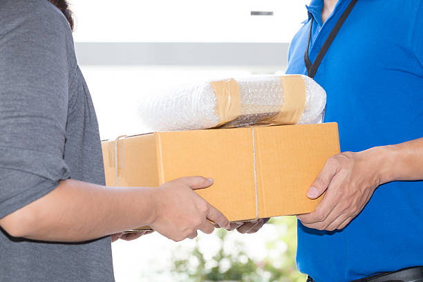 istock Woman hand accepting a delivery of boxes from deliveryman 610546646