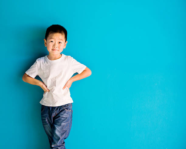 istock Chinese little boy against wall 610546822