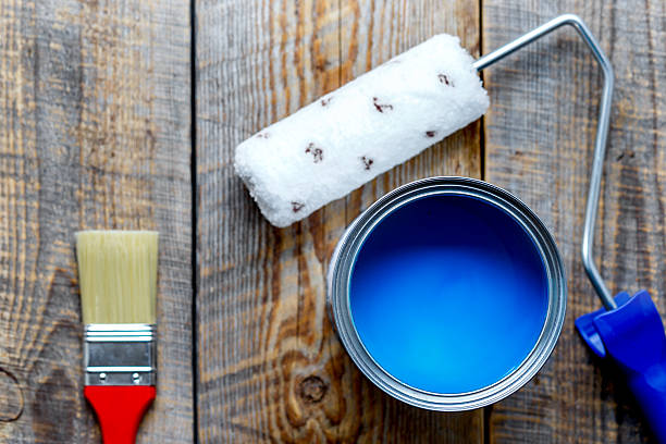 istock painting with can blue paint on wooden background 610547096