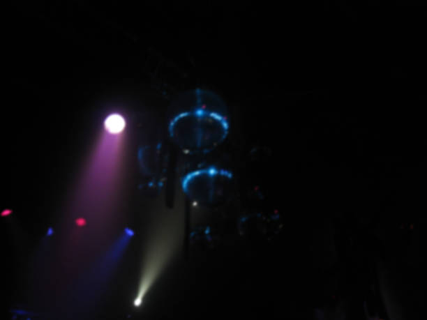 istock Disco party spotlights, disco ball and stage background. Blurry effect 610547262