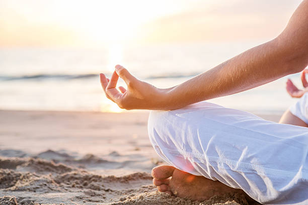 istock Caucasian woman practicing yoga at seashore 610547424