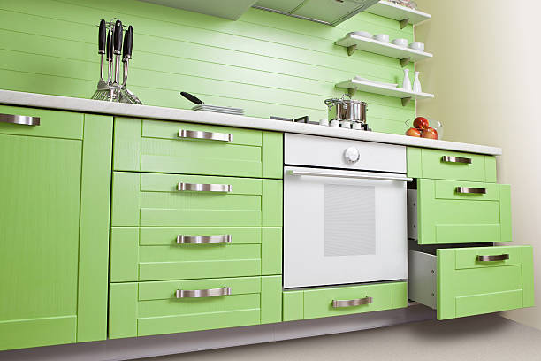 istock Luxurious new green kitchen with modern appliances 610548798