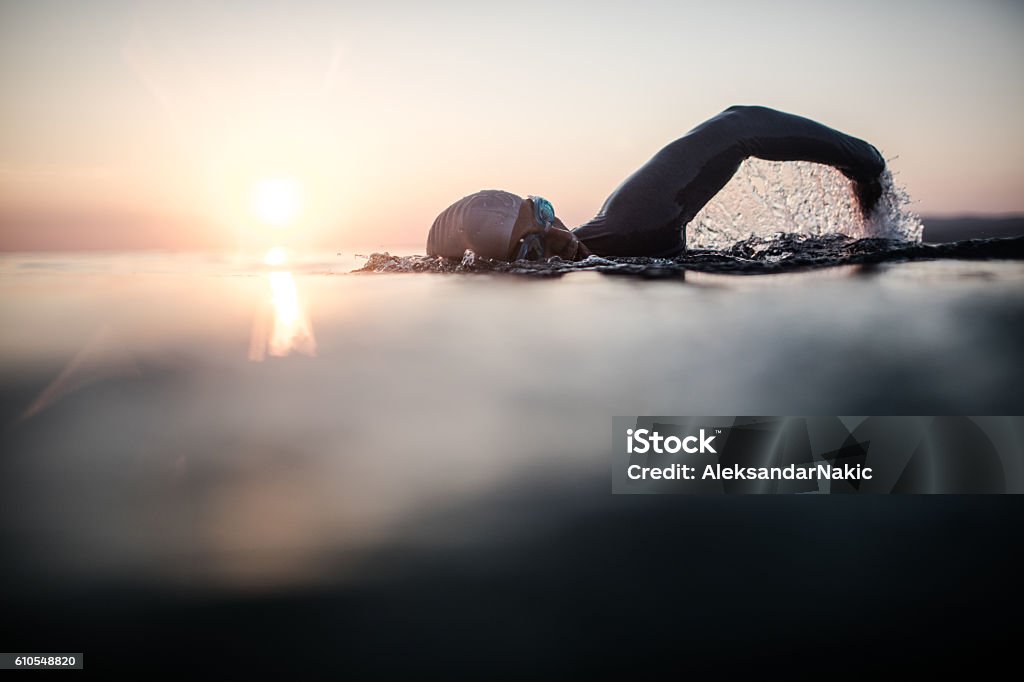 Swimmer in action Portrait of a determined male swimmer in action Swimming Stock Photo