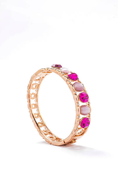 istock gold bracelet with pink stones on white background 610549808