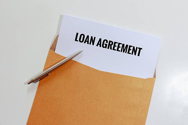istock Loan agreement in envelope with pen on table 610551256
