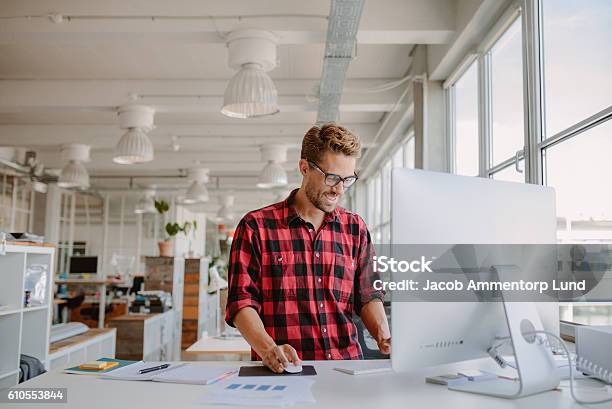 Young Man Working In Modern Workplace Stock Photo - Download Image Now - Graphic Designer, Design Professional, Office