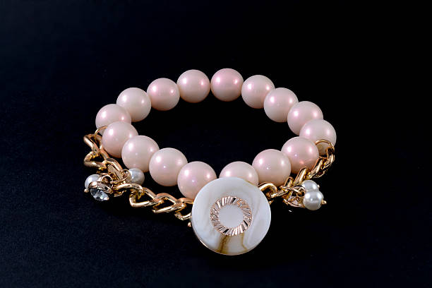 istock bracelet with pearls and pendants isolated on white 610553890