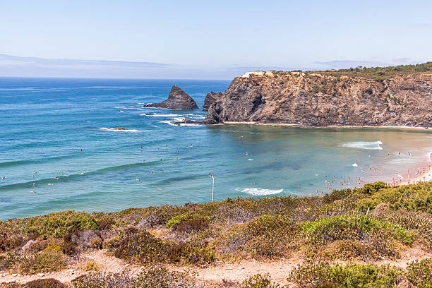 istock Coast with surfer at Odeceixe in Portugal 610555476