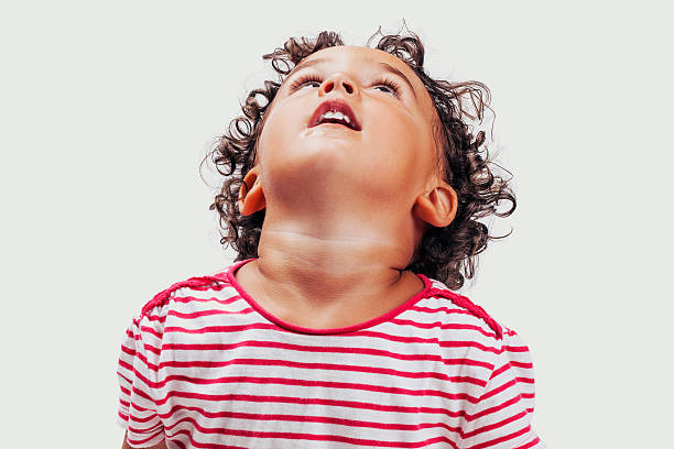 istock Close-up little boy looking up 610555668